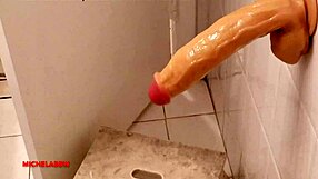 suggestive teen masturbates with big dildo in bathroom.