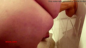suggestive teen masturbates with big dildo in bathroom.
