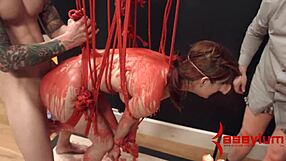 The redhead babe endures hot wax drips during intense bondage session