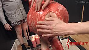 The redhead babe endures hot wax drips during intense bondage session