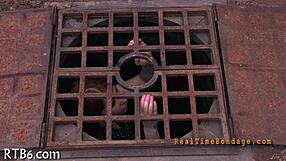 bound woman endures sadomasochism bondage session in dark room