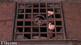 bound woman endures sadomasochism bondage session in dark room