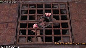 bound woman endures sadomasochism bondage session in dark room