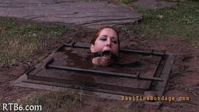 bound woman endures sadomasochism bondage session in dark room