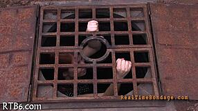 bound woman endures sadomasochism bondage session in dark room