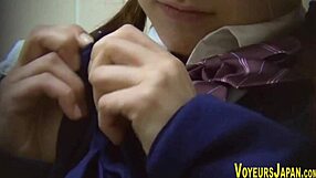 Japanese teen in uniform fingers her wet pussy suggestively