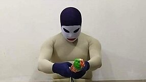 In the dungeon, zentai femdom inflicts painful CBT on slave's penis