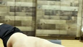 muscular bodybuilder stretches intensely in the gym