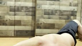 muscular bodybuilder stretches intensely in the gym