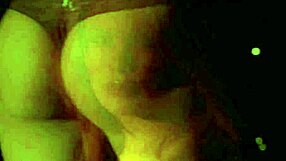 Between the shadows, she fingers herself passionately.