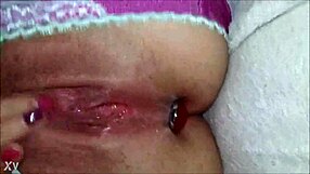 Amateur solo close-up of self-rubbing with plug