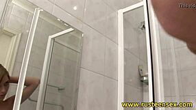 Blonde teen masturbates in shower with shaved pussy