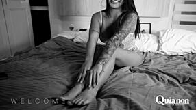 quianon posing intensely in bed