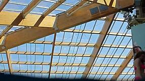 Lera swims naked with her big tits exposed