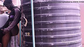 Ebony couple in doggystyle quickie behind tank, pussy exposed