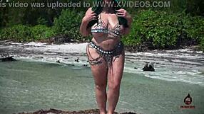 I watch the hot latina model shake her tits and ass on the beach.