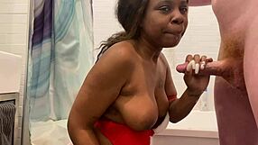 A black woman is almost chocking on a very large white rod