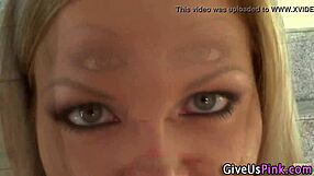 High-heeled blonde toys solo with a dildo in close-up