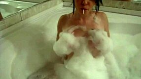 A small redheaded she-devil shows off her somehow perfect body while masturbating in a bathtub