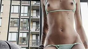 A thin-clad female in the bikini dances a plug on her terrace to her buttocks