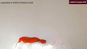 A brunette dances and performs on webcam in the bedroom.