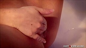 petite blonde fingers her shaved pussy with intense focus