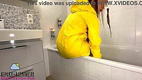girl in yellow rubber raincoat playing with a rubber duck teaser