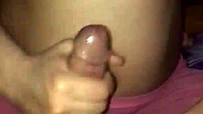 The wife gives a handjob with her big tits on display.