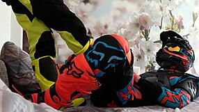 Motocross biker in costumes treads with boots suggestively