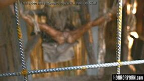 Beast licks bound woman outdoors.