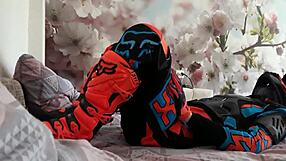 Motocross biker in costumes treads with boots suggestively