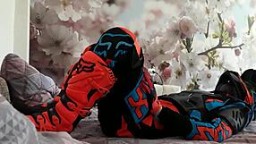 Motocross biker in costumes treads with boots suggestively