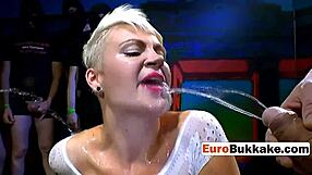 the short-haired beauty faces a group of huge cocks in an intense blowbang session