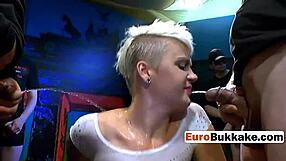 the short-haired beauty faces a group of huge cocks in an intense blowbang session