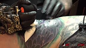 Marie Bossette masturbates her hairless pussy while getting tattooed backstage