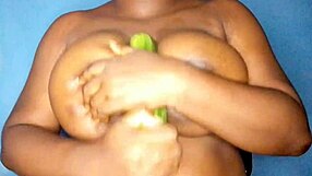 The ebony woman enjoys romancing with her busty features.