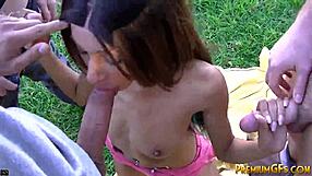 Trisha gives a blow job to five big cocks in a group session.