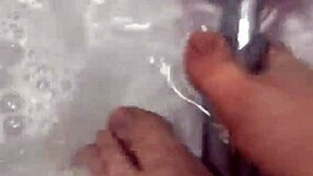 Nylon removal leads to a steamy shower scene with feet.