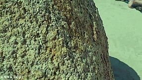 Two naked lesbians kissing on the beach.