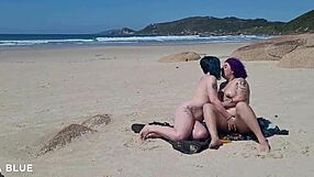 Two naked lesbians kissing on the beach.