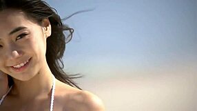 a cute japanese girl in a bikini shows off her big tits