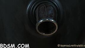 A woman receives attention while confined in a cage during a session