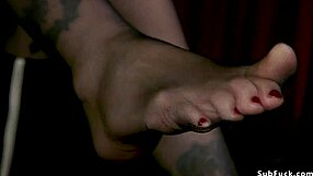 slave in gimp mask sucks strap on cock