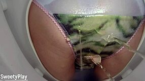 Pissing in panties while wetting on toilet bowl for cam close-up