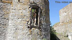 nude tattooed model poses at military base