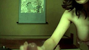 Hot Japanese babe with natural tits gives closeup handjob action