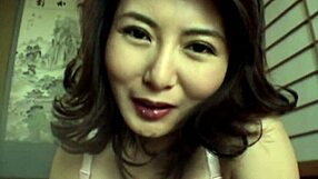 Hot Japanese babe with natural tits gives closeup handjob action