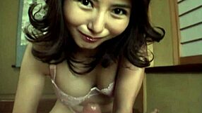 Hot Japanese babe with natural tits gives closeup handjob action