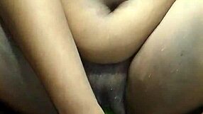 Big beautiful black woman enjoys a cucumber in her pussy