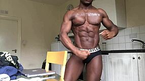 Gay black bodybuilder shows muscular body on webcam